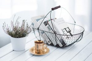 A decor cup and basket for books on table